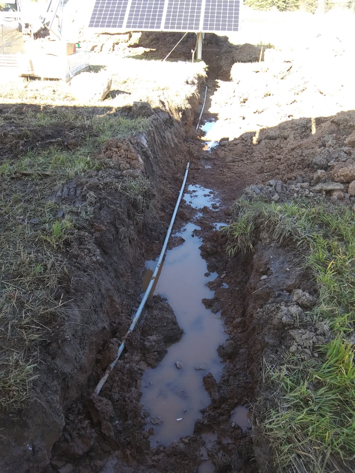 A ditch dug to install underground wiring to solar panels