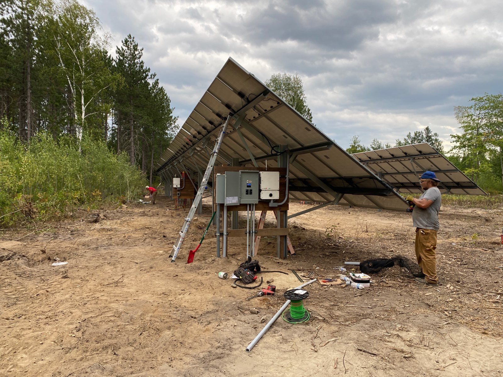 A solar installer works on a new solar grid