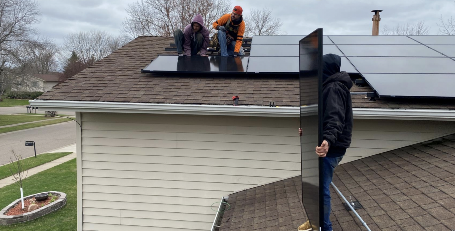 Roof with solar panels replacement services, installers in Minnesota replacing solar panels.